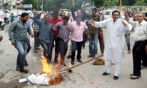 Teachers stage protest, burn effigy of Education Minister