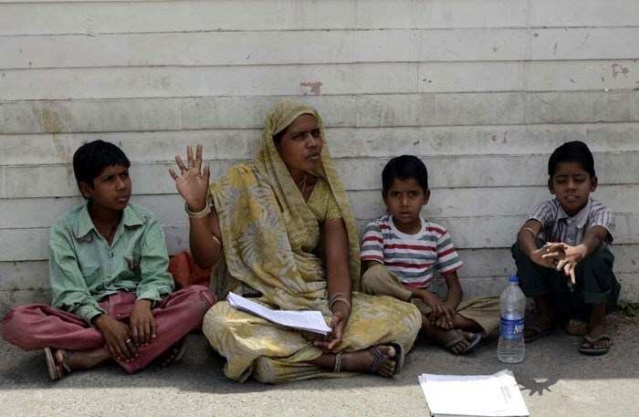 Woman with children sit on Hunger-Strike, demands her job back