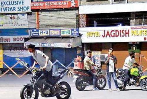 Bikers perform stunts near police station