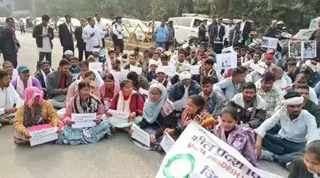 &ldquo;Tribal community members protesting outside Udaipur Collectorate demanding reinstatement of suspended teacher Bhanwarlal Parmar&rdquo;