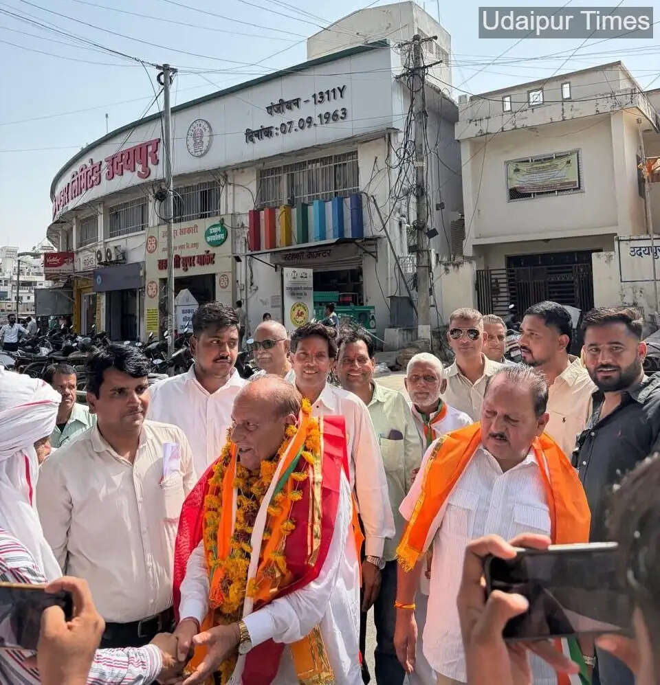 Congress-backed Mathuresh Nagda celebrating victory after being elected chairman of Udaipur Land Development Bank for the third time amid BJP protest