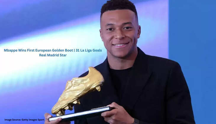 Kylian Mbappe holds the European Golden Boot trophy at Santiago Bernabeu, smiling with Real Madrid officials applauding in the background.