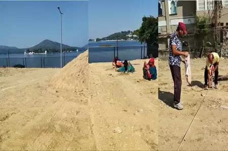 Temporary beach volleyball court being prepared behind Mahakal Temple at Fateh Sagar Lake, Udaipur.