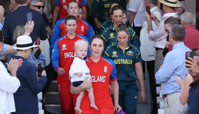 England captain Nat Sciver-Brunt carries her son Theo onto the field before the ICC Women's T20 World Cup 2026 final at Lord's against Australia.
