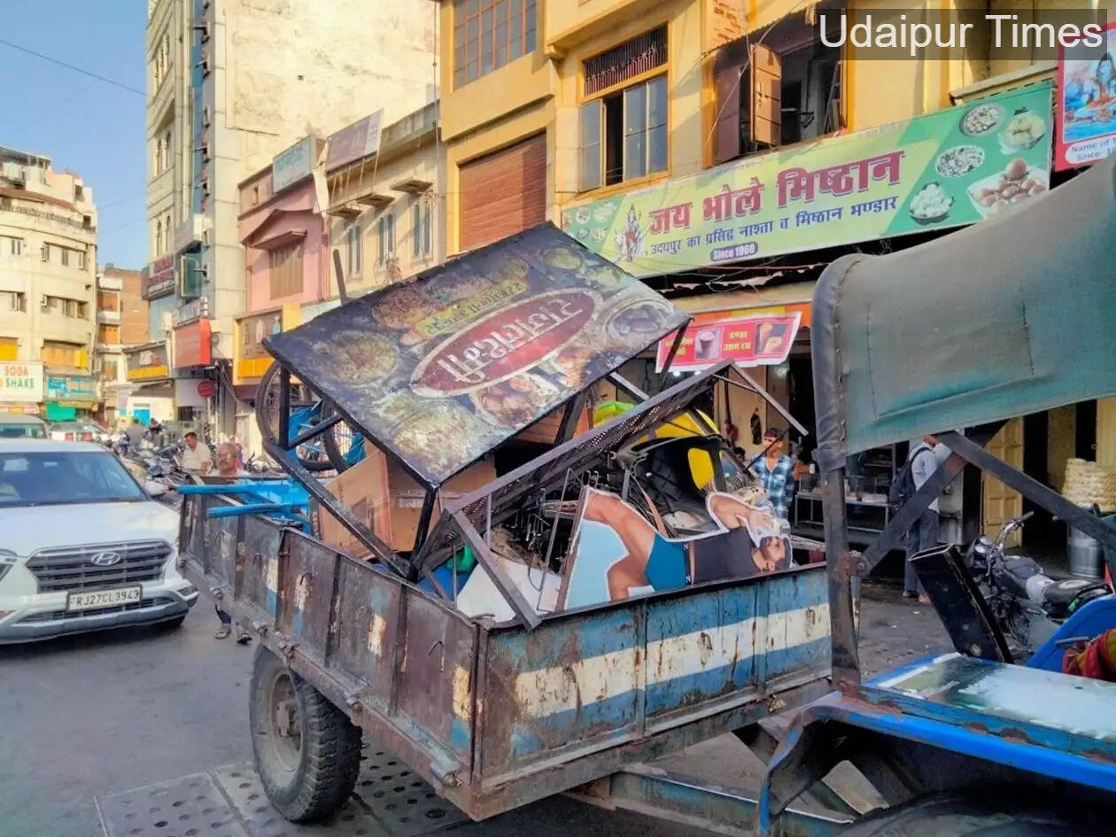 Municipal corporation workers removing temporary encroachments from Surajpol to Dhanmandi area in Udaipur to improve traffic movement and public convenience.