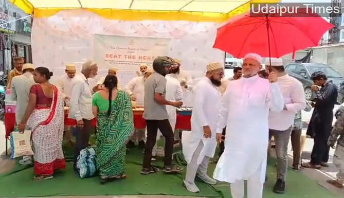 Members of the Bohra community distribute chilled buttermilk under the &lsquo;Beat the Heat&rsquo; initiative at Delhi Gate intersection in Udaipur to provide relief from rising summer temperatures.