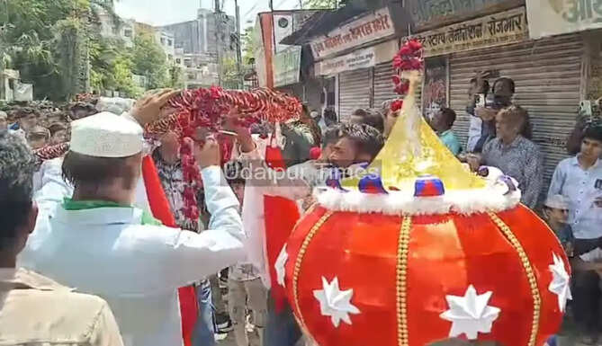Muslim community members participating in the traditional Muharram stick procession with ceremonial Chhadis and Alams in Udaipur.