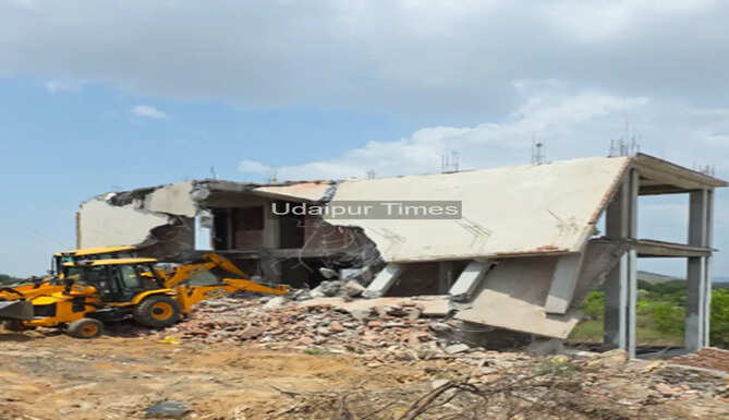 UDA officials demolishing a 5,000 sq ft illegal building constructed using a fake lease on government land in Hawala Khurd, Udaipur.