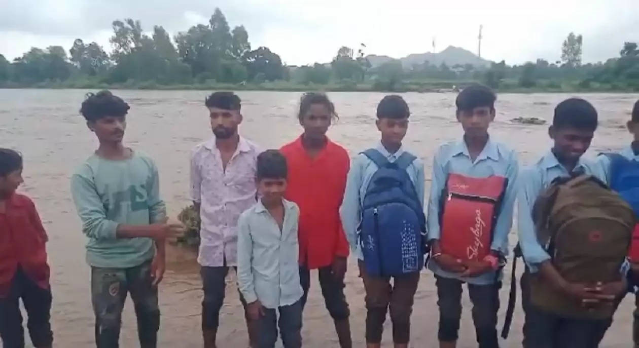 Students crossing river at Jhadol