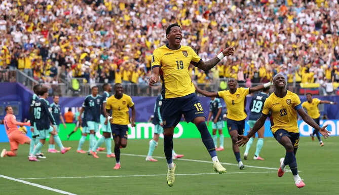Ecuador players celebrate after defeating Germany 2-1 to qualify for the FIFA World Cup knockout stage as fans erupt inside the stadium.