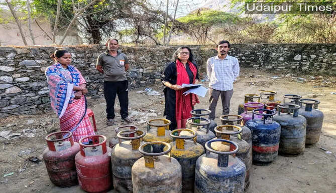 Officials seizing illegal commercial and domestic gas cylinders during a raid in Udaipur