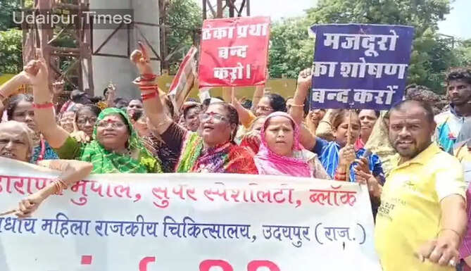Contract employees protesting outside RNT Medical College in Udaipur demanding salary hike and permanent employment.