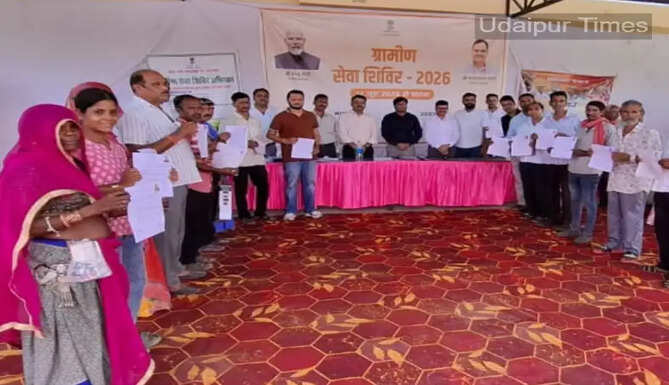 Officials interacting with residents during rural and urban service camps organized in Udaipur district under Rajasthan government's welfare campaign.