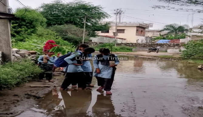 Villagers from Gupri village in Udaipur submit a memorandum demanding repairs to a waterlogged road and safety measures around a roadside electricity transformer.
